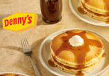 A stack of fluffy, buttermilk pancakes alongside a Sweet Cream Cold Brew