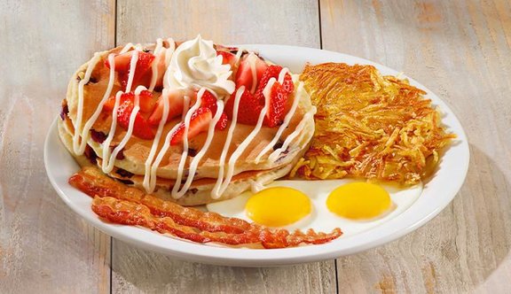 Denny's pancakes served with two eggs and golden hash browns